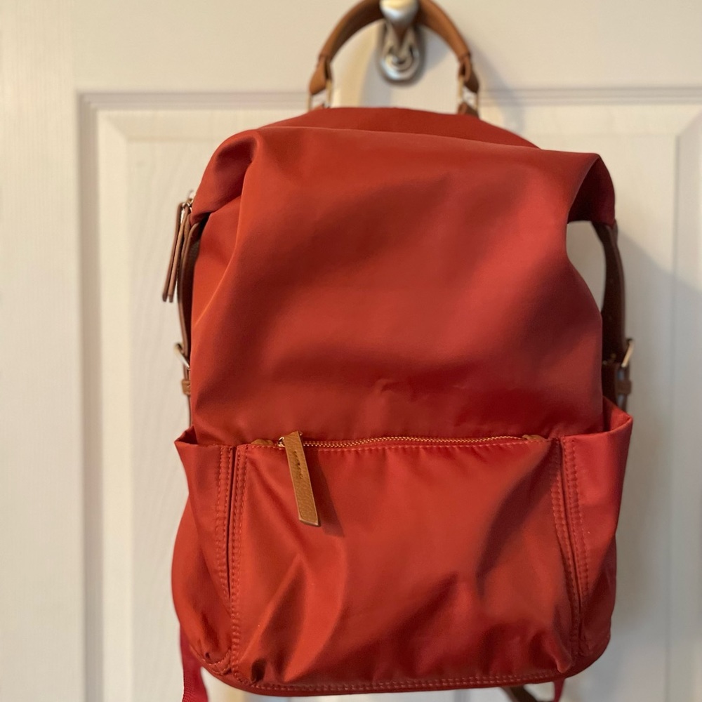 Tommy Bahama nylon and leather backpack with multiple zip and slip pockets